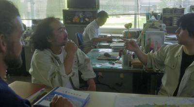 デスクで話し合いをしている人たちの写真