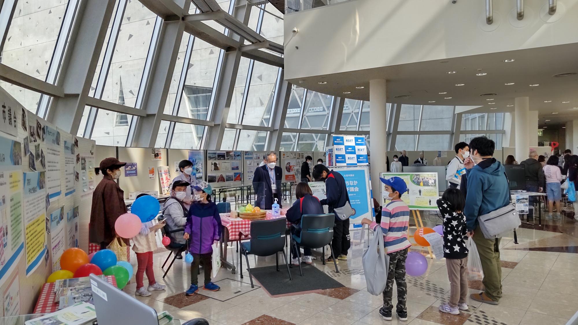 壁に色々な掲示物が貼られた館内に親子が集まっている写真